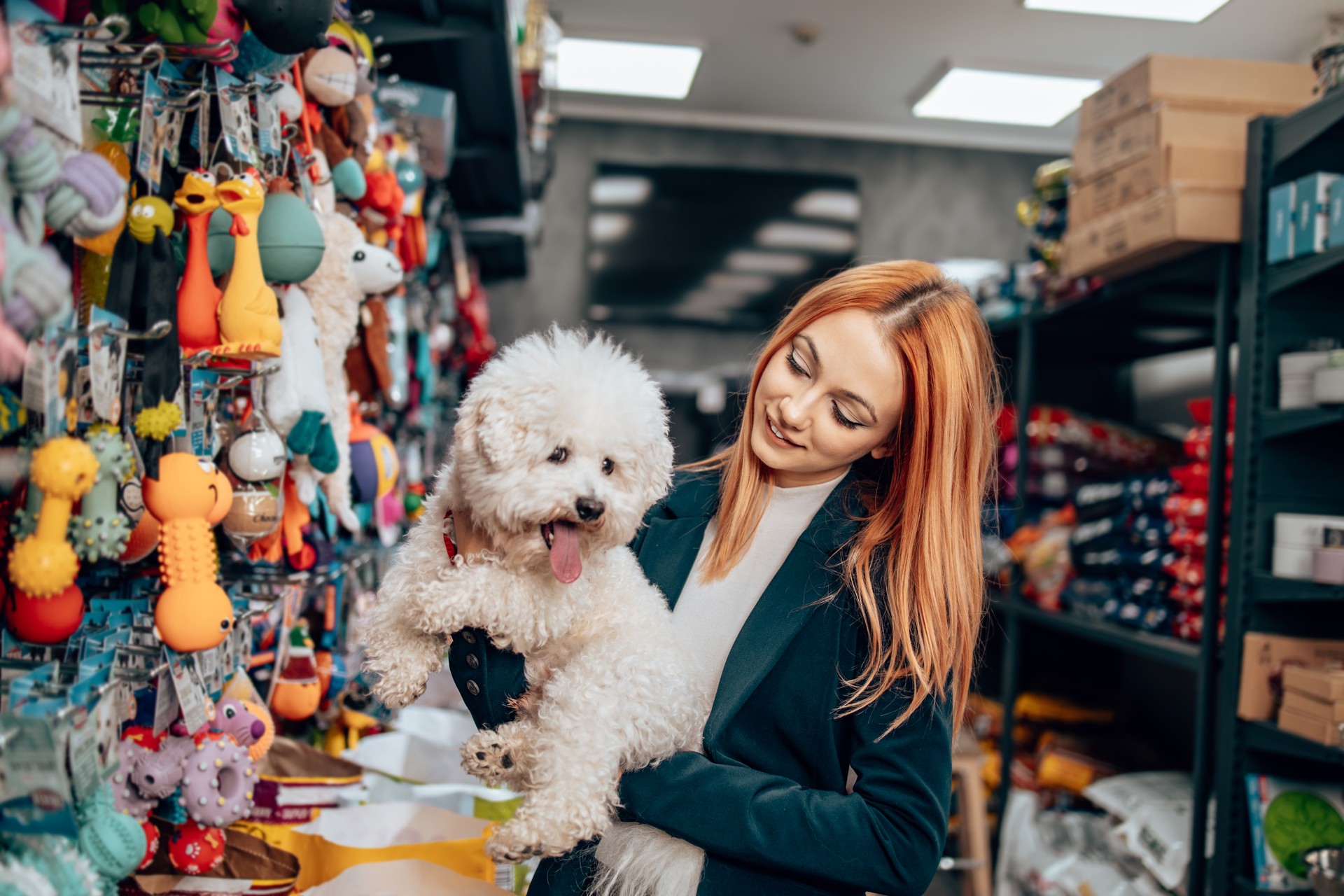 Beautiful woman with dog in a pet shop